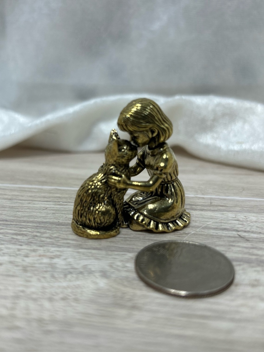 A Brass Trinket of a little girl and her cat